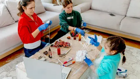 Family making crafts with online tutorial