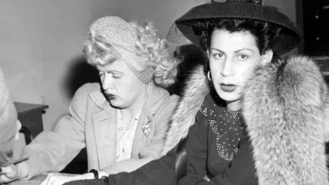 James Barlow, left, also known as Jeri Ryan, and August Coy, also known as Irene Paston, at the city hall police station. Photograph dated November 27, 1944. 