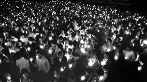 Photograph caption dated May 27, 1983 reads, "Some of the 5,000 people who rallied at Westwood Federal Building in support of more AIDS research funds." 