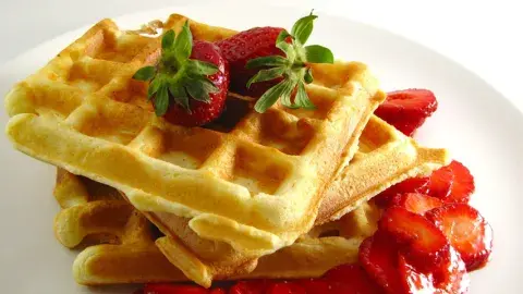 waffle with syrup and strawberries