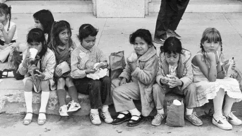 Children eating lunch b & w photo from 1983