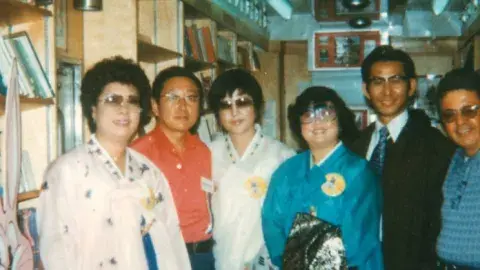 Korean Americans and library staff inside a Los Angeles Public Library Bookmobile that is participating in an annual Korean parade.