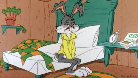 a very sleepy bugs bunny getting out of bed
