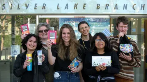 teens holding art supplies in front of the Silverlake Branch Library