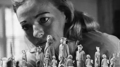 close up of woman staring at a chess board