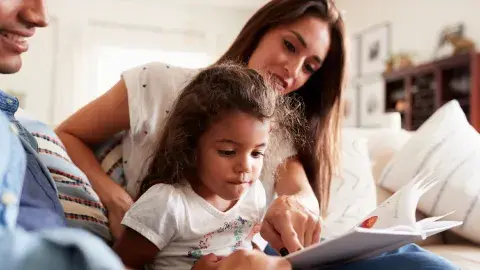 family reading a book together