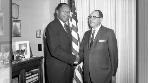 Tom Bradley (left) shakes hands with William Byron Rumford