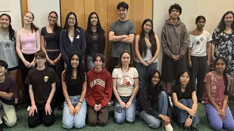 group of 18 teens gathered for a meeting