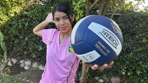 Sofia Perez holdingup a soccer ball