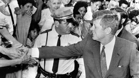 John Kennedy Shaking Hands in Crowd