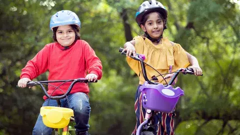 Two kids happy on their bikes