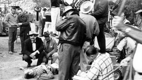 A close-up shot is lined up by the director and cameraman during a Maverick shoot on the Warner Bros. lot in Burbank, [1961]. Valley Times Collection