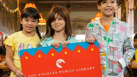 three kids hold a huge student success card