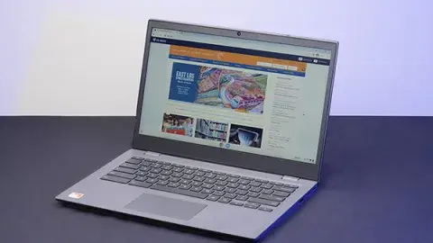a laptop computer open on a tabletop, displaying the los angeles public library website