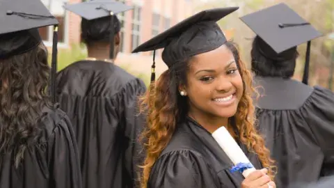 Young woman graduate with other graduates