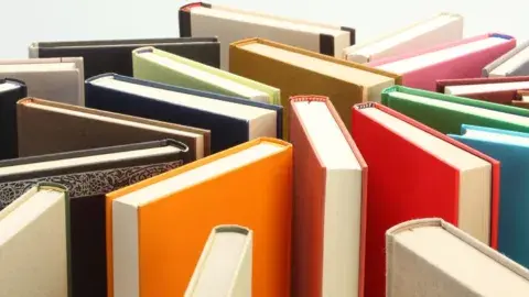 Several books standing on end in a random arrangement.