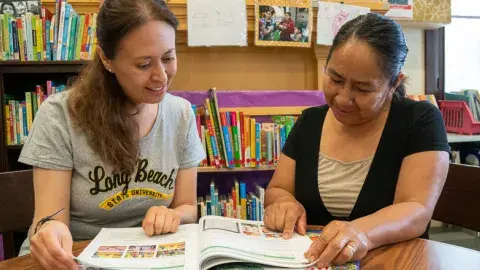 A tutor working with an adult learner