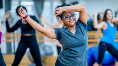 Women are waving their arms while exercising.