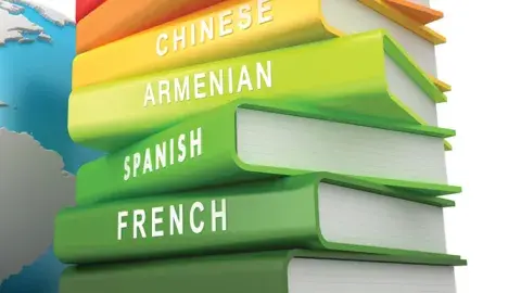 Stack of language books, including French.