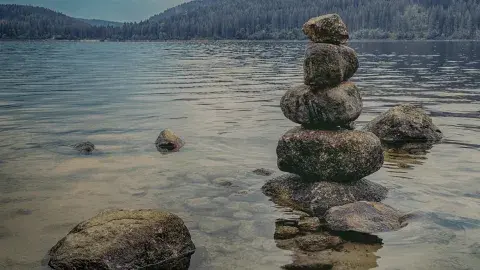 rocks stacked at the shore of a lake