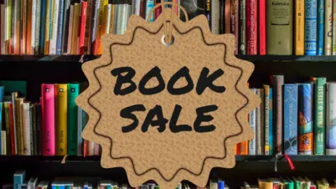 a bookshelf with the text "Book Sale" in the center