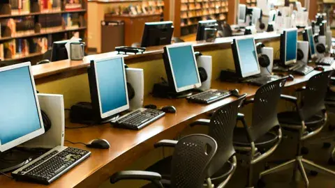 A row of computers in a library
