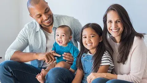 Mother and father sitting with two children