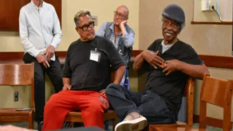 individuals participating in neighborhood sing program