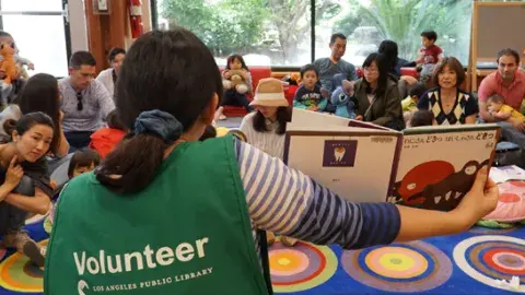 STAR volunteer reading to children
