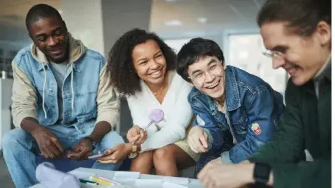 A group of happy adults talking and laughing together