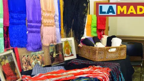 colorful rebozos on display in a library