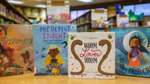 Children's Picture Books shown on a wooden table.
