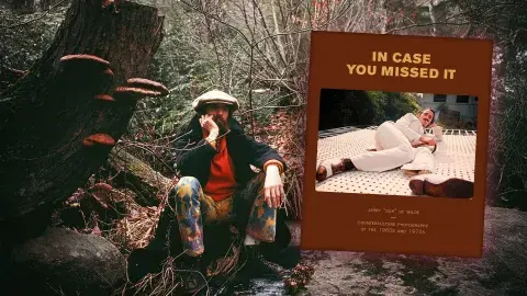 Jerry de Wilde in a forest next to his book