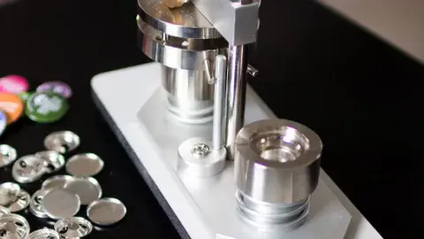 image of a button press next to a pile of unmade buttons