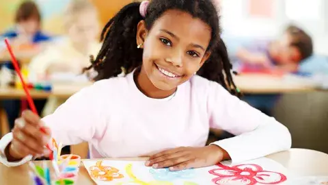 A young girl painting 