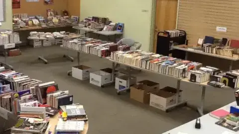 A used book sale in a library meeting room