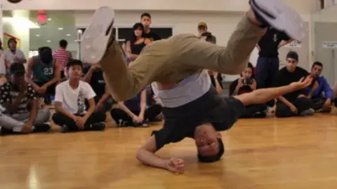 Eric Nishimoto demonstrating breakdancing. 