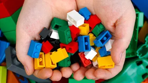 Hands holding building bricks