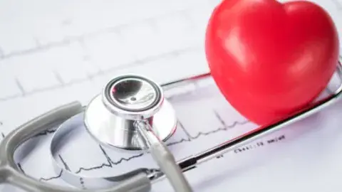 image of a stethoscope and a plastic heart