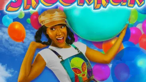 woman in a hat surrounded by colorful balloons