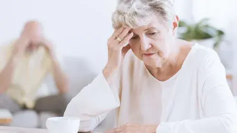 seniors looking down with head in hands