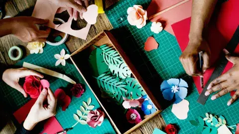 picture of various crafts and hands touching them