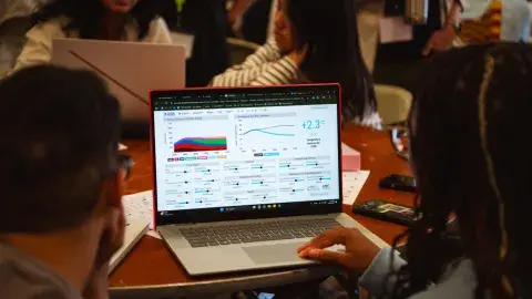 People using a climate simulator program on a computer