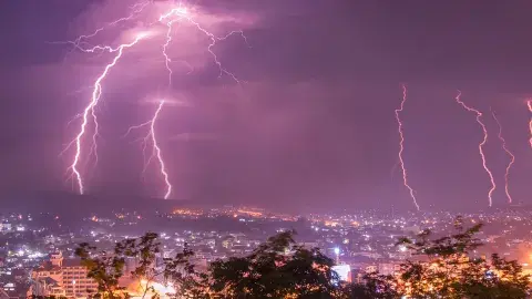 lightning flashes over city scape
