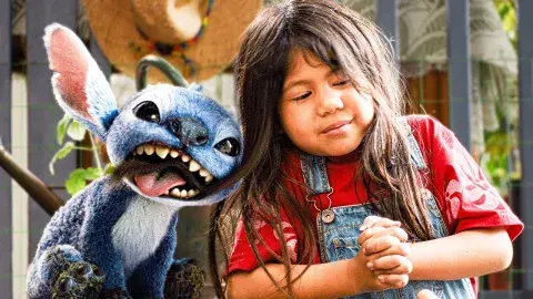blue character and little girl next to each other