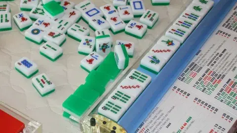 Image of the game of Mah Jongg tiles in mid-game.