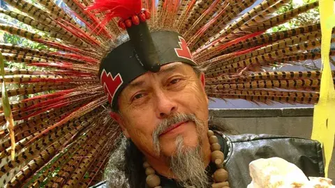 man with feather headdress