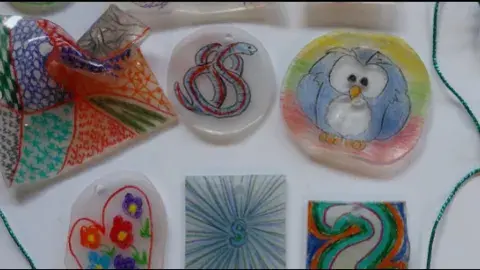 image of a number of shrinky dink amulets laid out on a white background