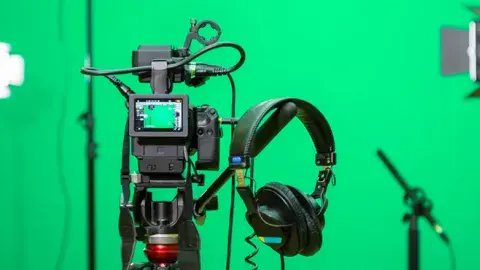 Green screen with camera and headphones