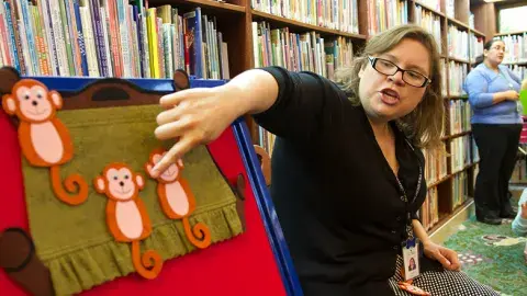 Librarian pointing to felt board during Storytime